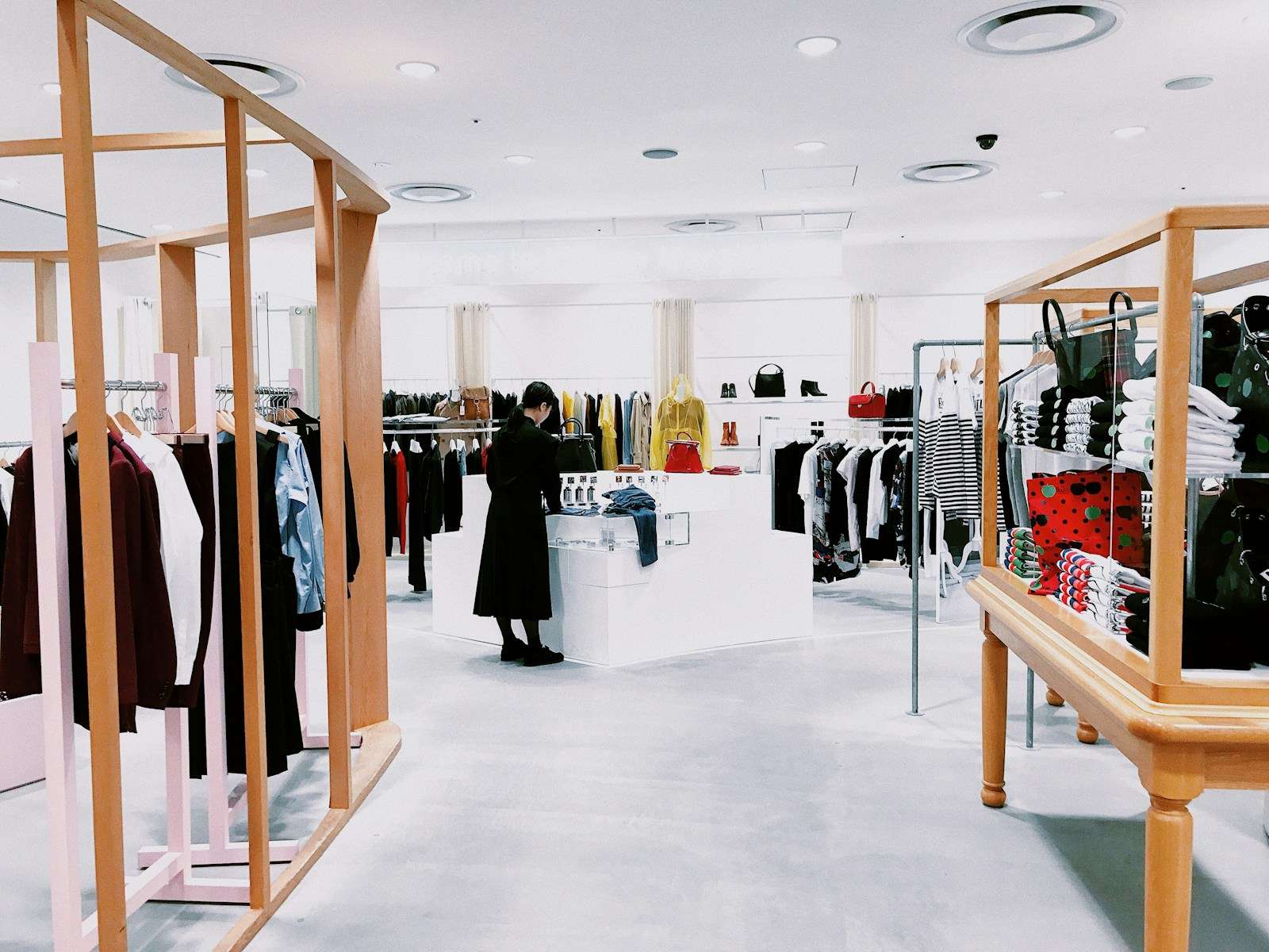 woman standing inside clothing area, Premium Retail